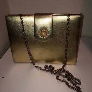 Luxurious Gold Clutch with Chain Strap and Circular Closure. Lipstick holder
